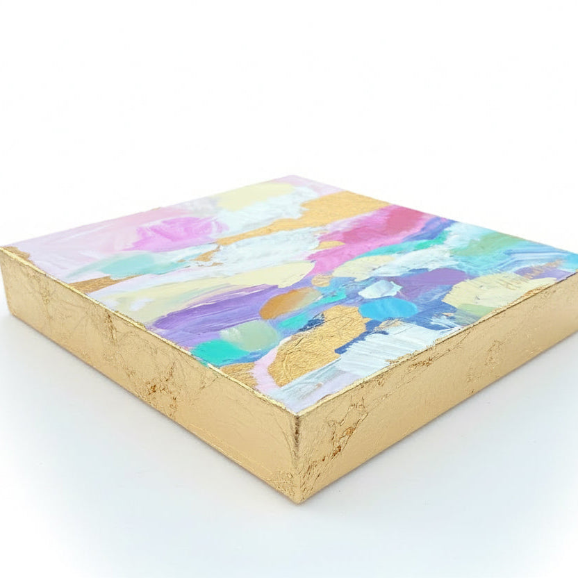 A small colorful abstract acrylic landscape painting with gold leaf edges shown from side view by Phoenix artist Julie Hamilton