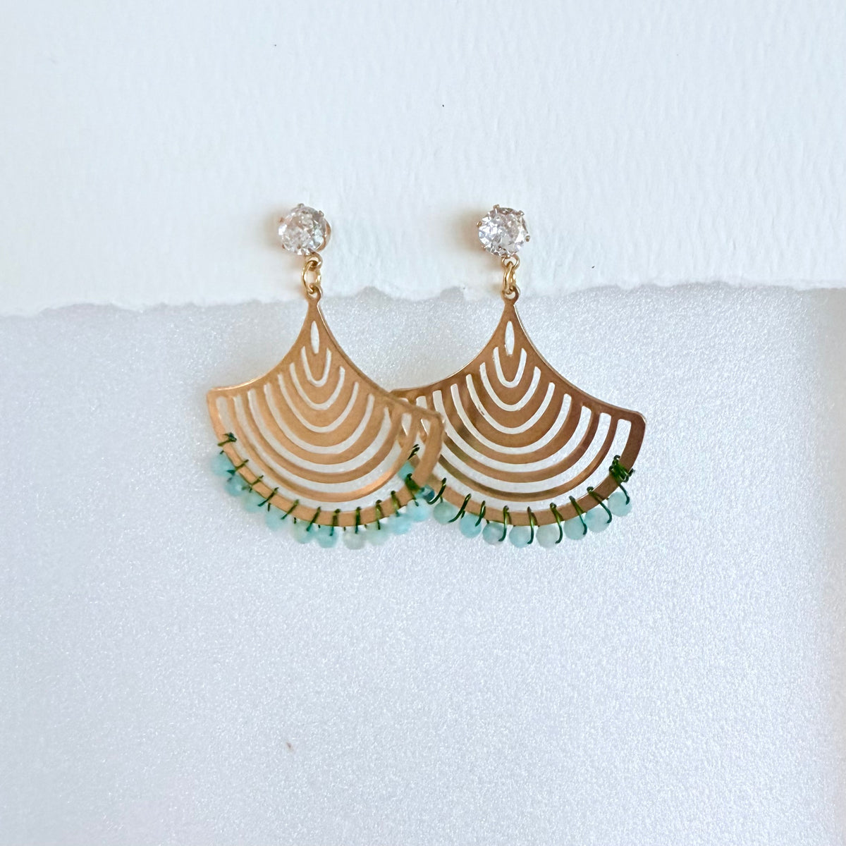 Aquamarine blue beaded earrings with cubic zirconia stud on a white background by artist Julie Hamilton