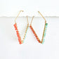 Pair of coral and ultramarine beaded hoop earrings with a white background by phoenix artist Julie Hamilton 