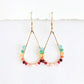 Gold hoop earrings with faceted rainbow beads on a white background by artist Julie Hamilton