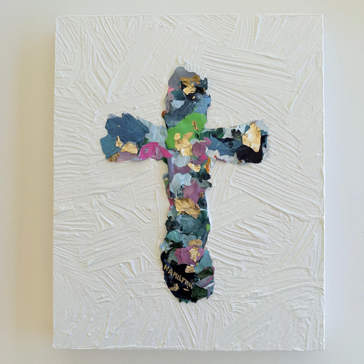Colorful cross collage on a textured white canvas  and gold leaf with white background