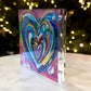 Colorful heart-shaped artwork on a clear block with blurred lights in the background