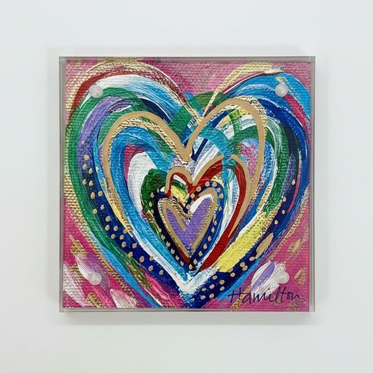 Colorful heart-shaped artwork on a white wall