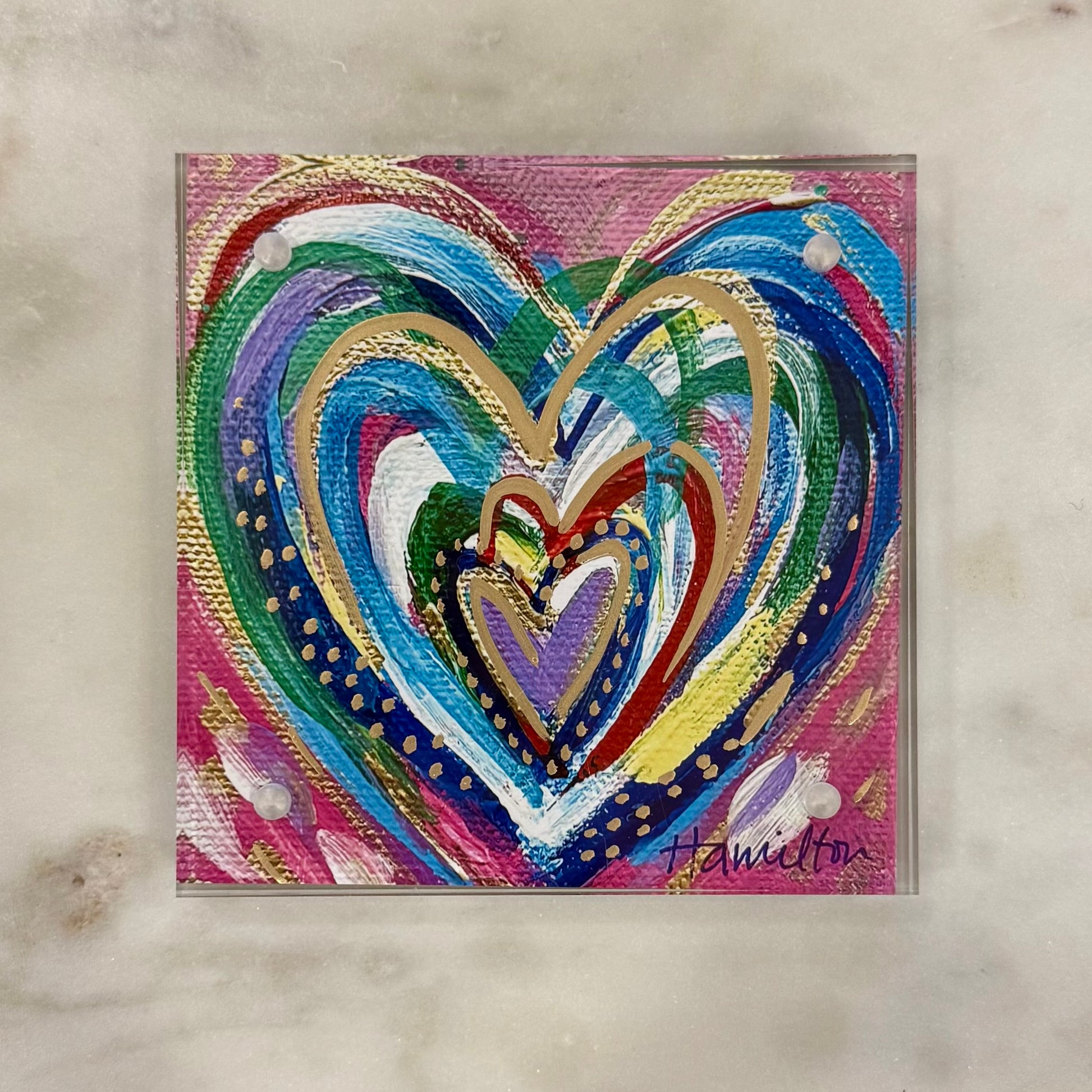 Colorful heart-shaped artwork with swirling patterns on a textured surface