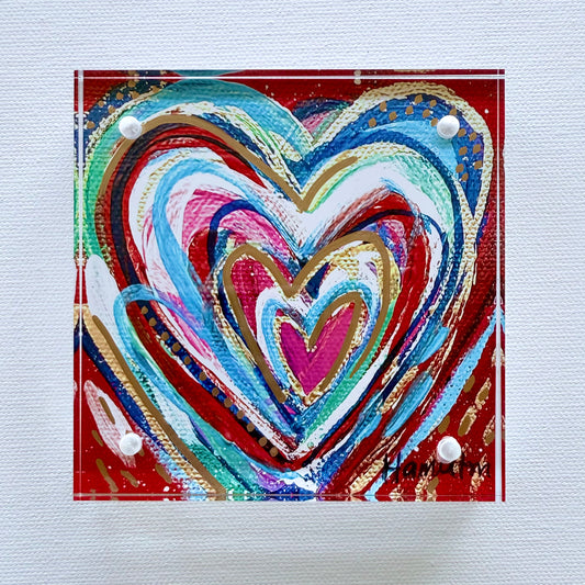 Colorful heart-shaped artwork on a textured surface