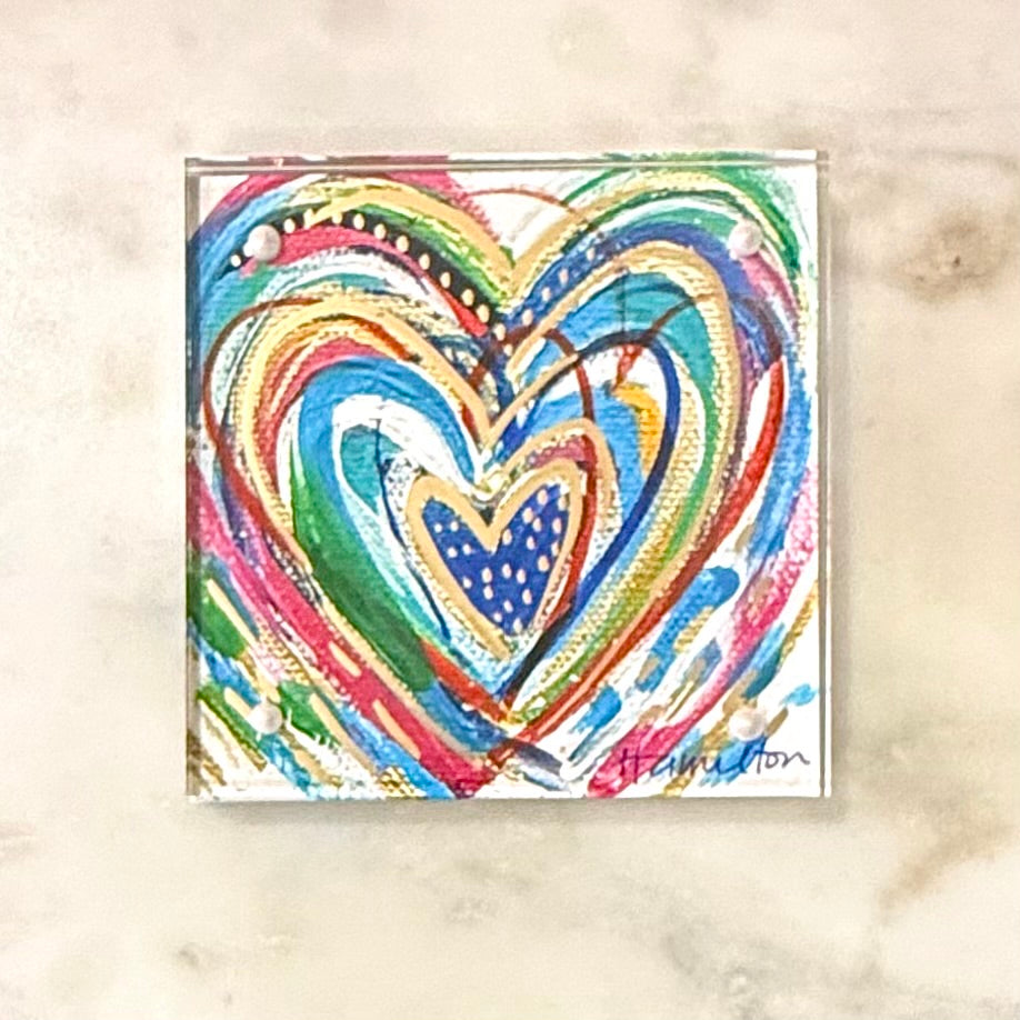 Colorful heart-shaped artwork on a textured beige background