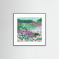 Framed art print of a colorful floral landscape on a white wall