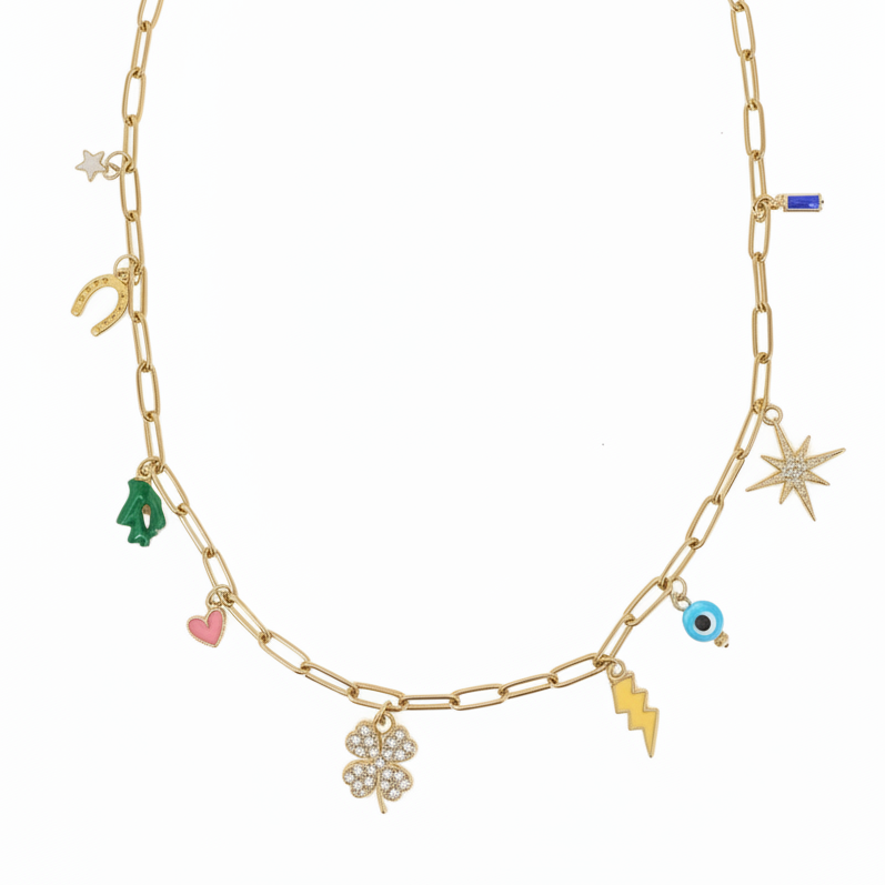 Gold chain necklace with various lucky charms on a white background