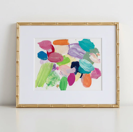 Framed abstract artwork with colorful brush strokes on a white background