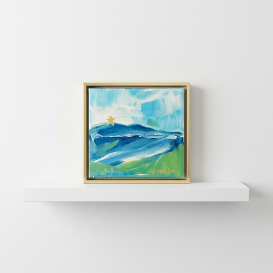 Framed abstract painting of mill mountain star on a white shelf against a white wall
