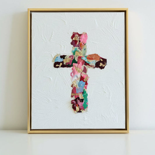 colorful framed artwork of a collaged cross on textured white canvas and white background