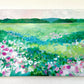 A large impressionistic floral painting by phoenix artist julie hamilton in soft greens, pinks, and blues on a white wall