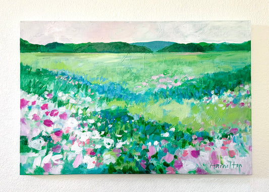 A large impressionistic floral painting by phoenix artist julie hamilton in soft greens, pinks, and blues on a white wall